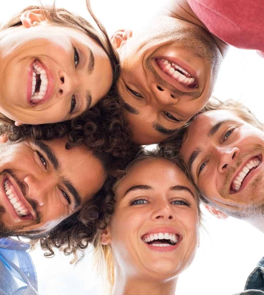 Smiling person showcasing white teeth after laser whitening treatment Rugby